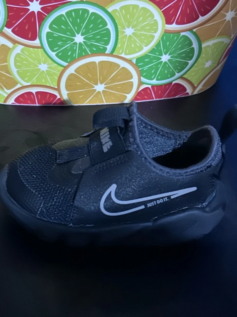 Nike Youth Black Slip-On Sneaker with White Swoosh and Blue Insole